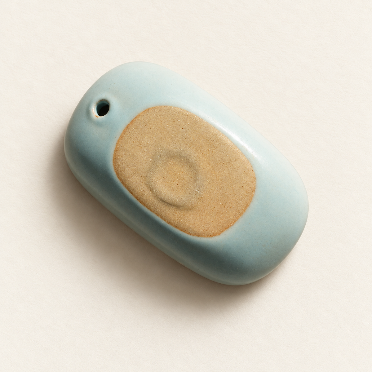 Underside of the celadon ceramic incense holder with its unglazed clay base