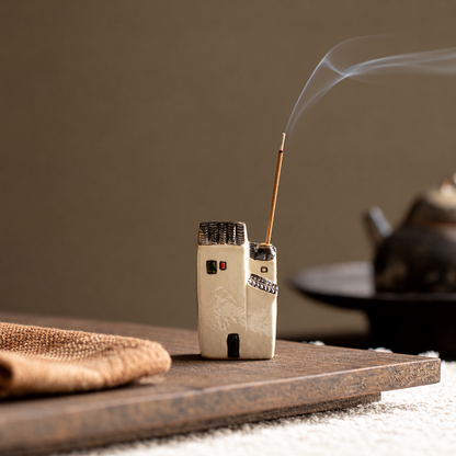 Tall ceramic house incense holder with an incense stick on a wooden board; scene props are not included