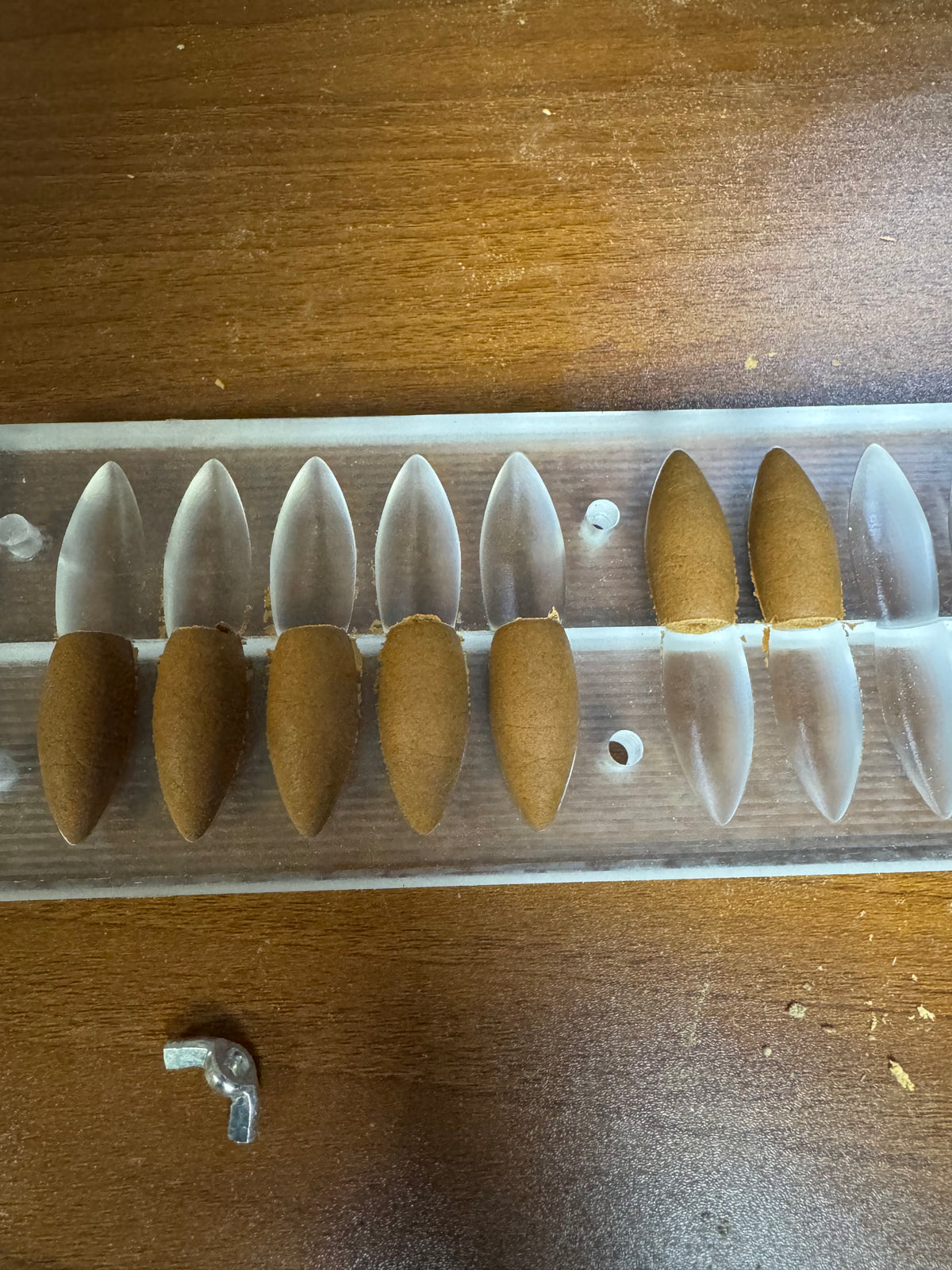 Backflow incense cones resting in an opened mould